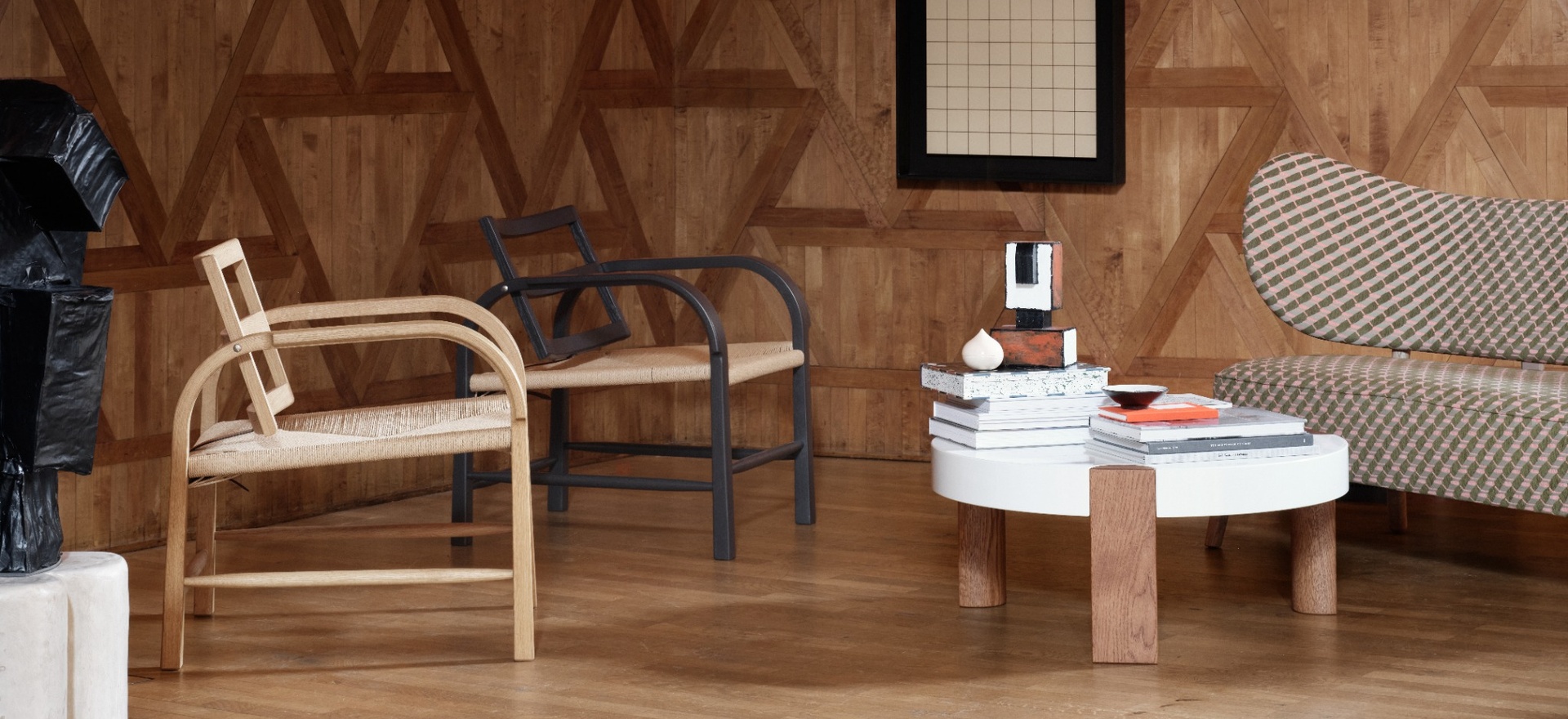 Interior setting with a lounge chair, marble table and natural textures