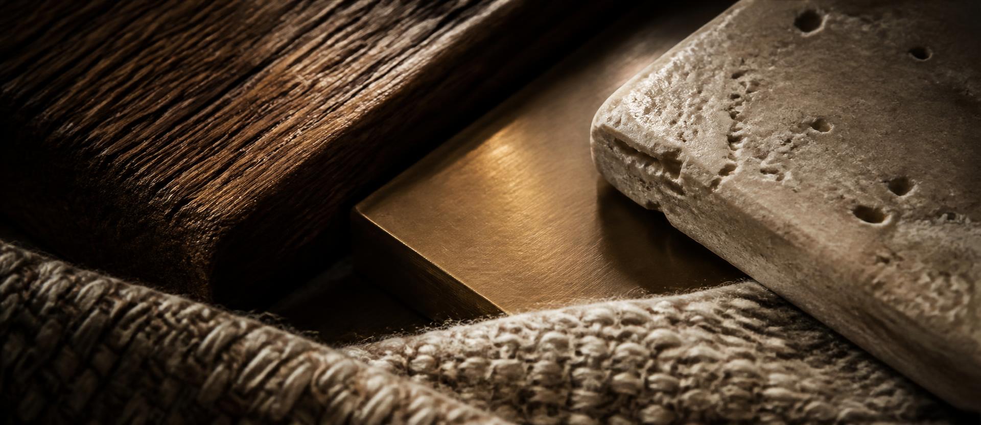 Close-up of oak, brass, travertine and woven wool materials